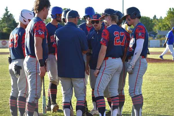 Medford Mustangs 2025 team huddle on the field