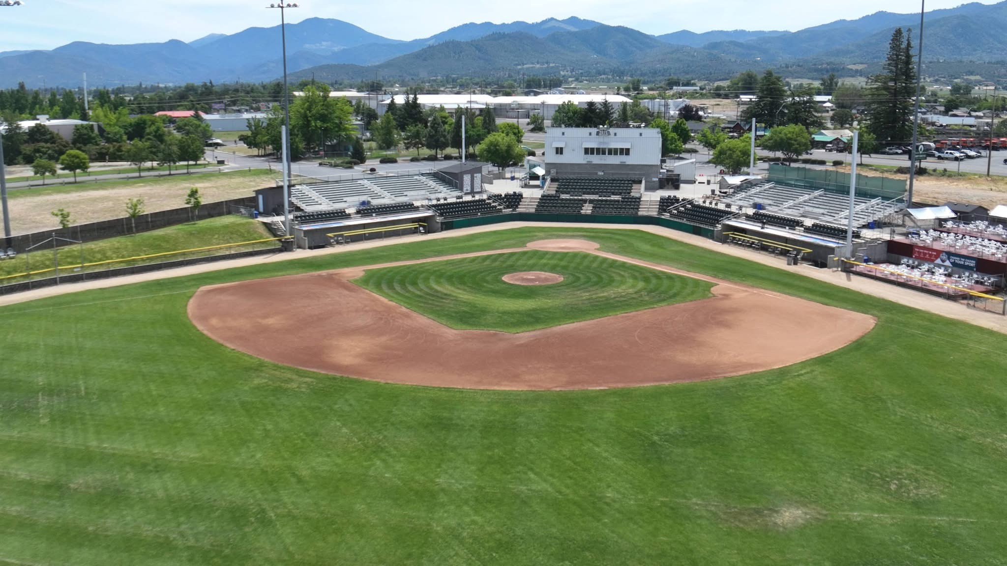 Aerial view of Harry & David Field in Medford, Oregon with the Rogue Valley mountains behind the outfield &mdash; host venue for the 2026 Oregon AAA American Legion State Tournament.