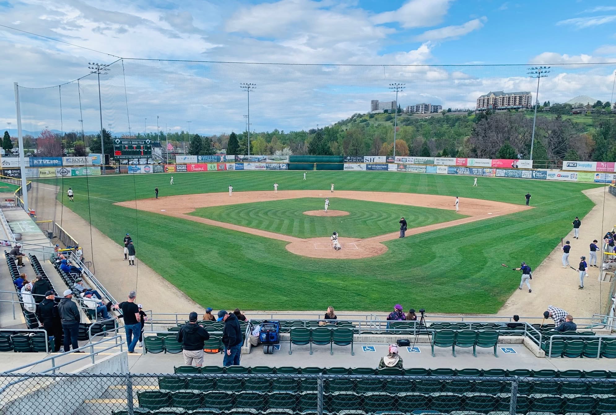 Harry & David Field in Medford, Oregon &mdash; home of the Medford Mustangs and host venue for the American Legion Baseball Northwest Regional (Region 7). View from behind home plate during a Mustangs game with the Rogue Valley hills in the background.